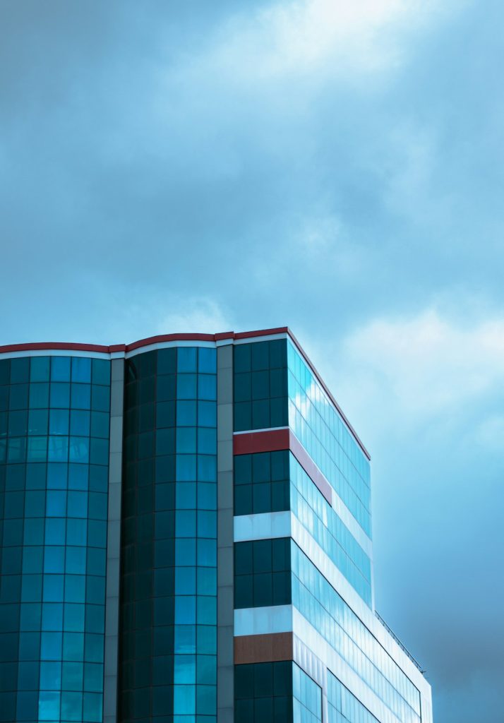a-tall-building-with-a-clock-on-the-side-of-it-g-fo8k5bhtu