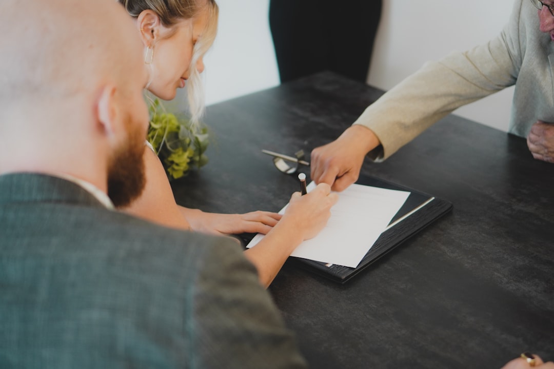 couple-signing-document-at-desk-wnxbeonug-4